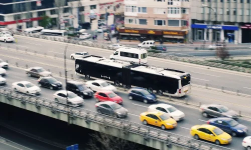 Vue aérienne d’une route urbaine avec voitures et taxis, image illustrant le convoyage de voiture et la circulation organisée en milieu citadin.